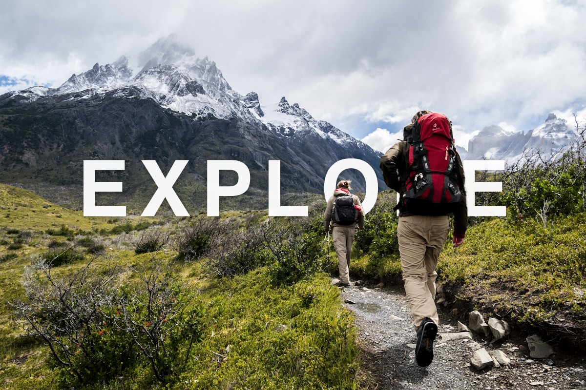 Hikers with EXPLORE text behind the subject