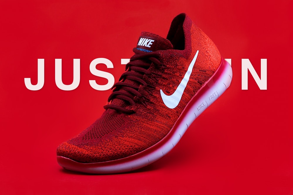 Red sneaker with JUST RUN text behind the product