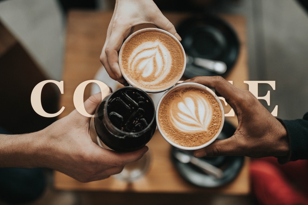 Coffee cups with COFFEE text behind the subject